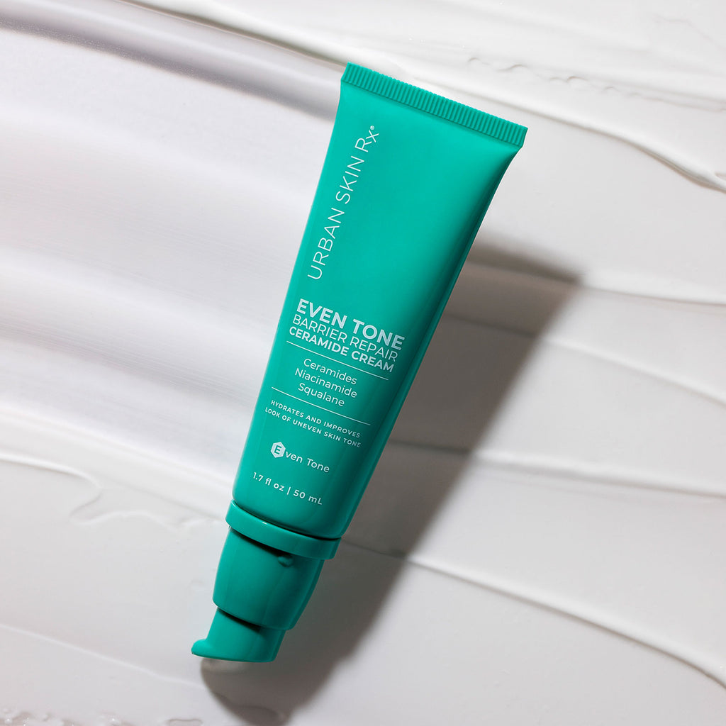 Bottle of USRX Even Tone Barrier Repair Ceramide Cream on white background