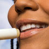Woman applying Urban Skin RX Cool Mint Sunscreen Lip Balm to her lips