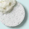 Lather of the Even Tone Cleansing Bar applied to a cleansing sponge