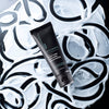 Bottle of Urban Skin RX Even Tone Soothing Moisturizer against black and white background