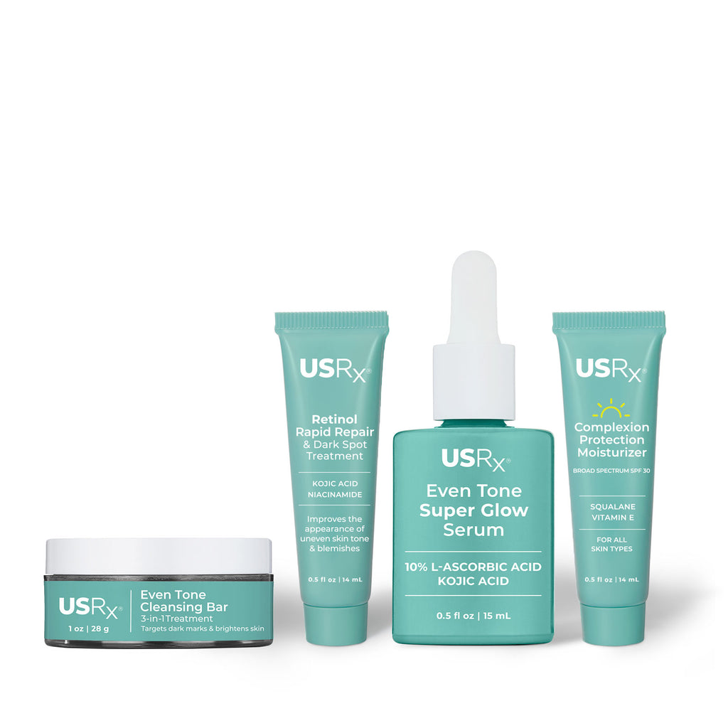 Assortment of bottles of Urban Skin RX Even Tone Super Glow Serum, Even Tone Cleansing Bar, Retinol Treatment, and Complexion Protection Moisturizer Sunscreen promote even skin tone